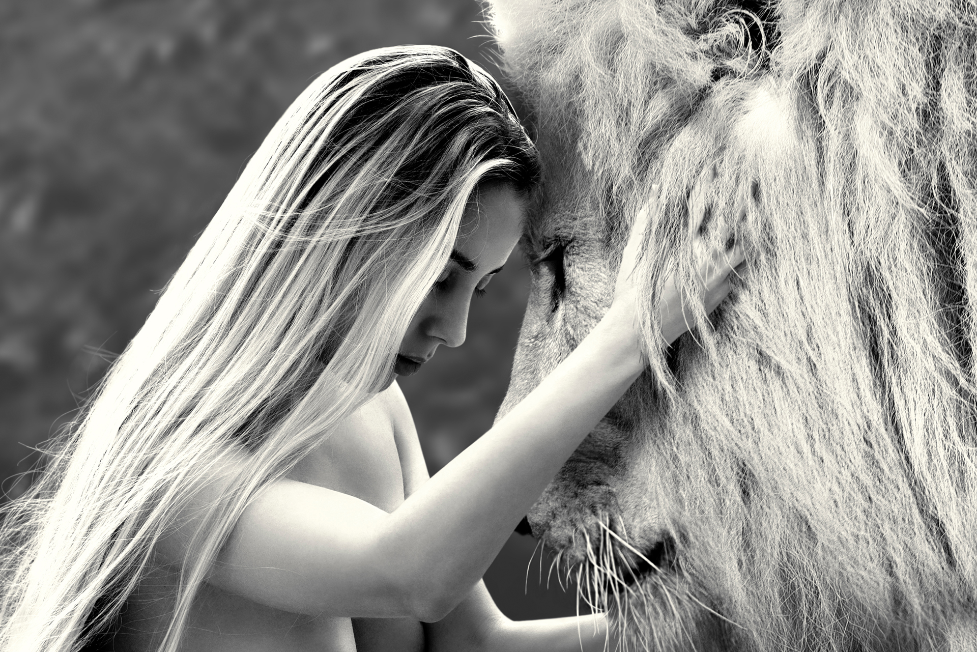 Closeup of a woman hugging a lion